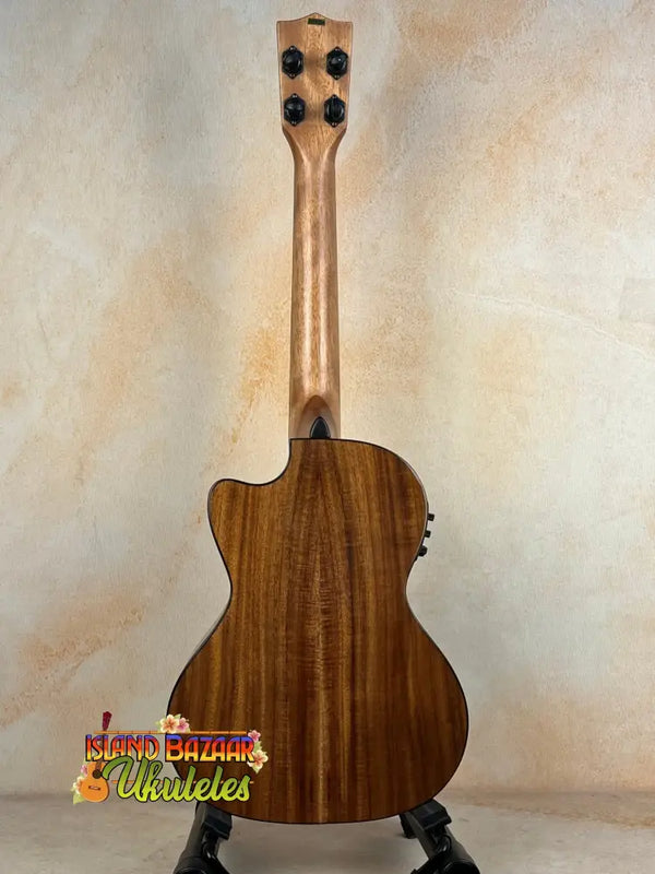 Wooden Kala KA-SCAC-T-CE Tenor Ukulele with natural finish on black stand