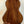 Wooden acoustic guitar with brown grain patterns beside Kala KA-SCAC-T6 6-string tenor ukulele