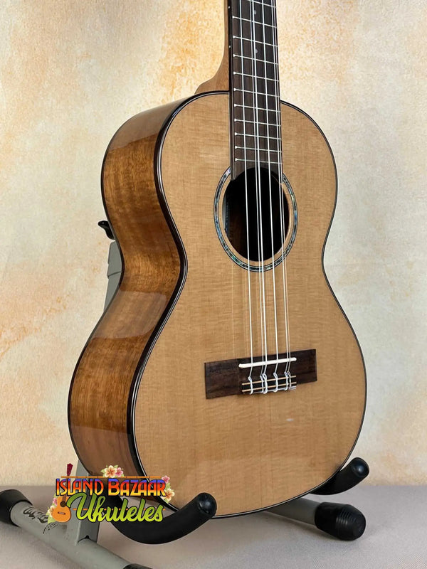 Wooden Kala KA-SCAC-T6 6-String Tenor Ukulele with Cedar Top on a black stand