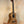 Natural wood Kala KA-SCAC-T6 6-string tenor ukulele on black stand