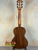 Classical acoustic guitar with wooden body highlighting Kala KA-SCAC-T6 6-string tenor ukulele