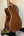 Acoustic guitar with brown wood grain on a stand, showcasing Kala KA-SMH-TG-CE Tenor Electric Ukulele