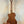 Wooden acoustic guitar on black stand showcasing Kala KA-SMH-TG-CE Tenor Electric Ukulele