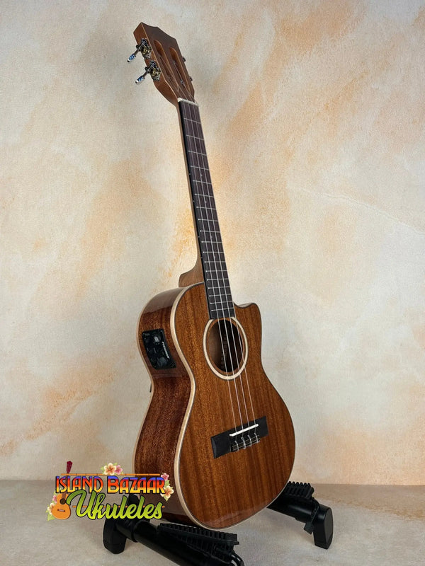 Wooden Kala KA-SMH-TG-CE Tenor Electric Ukulele on a black stand, showcasing solid mahogany