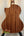 Acoustic guitar with brown wooden back panel beside Kala KA-SMH-TG-CE Tenor Electric Ukulele