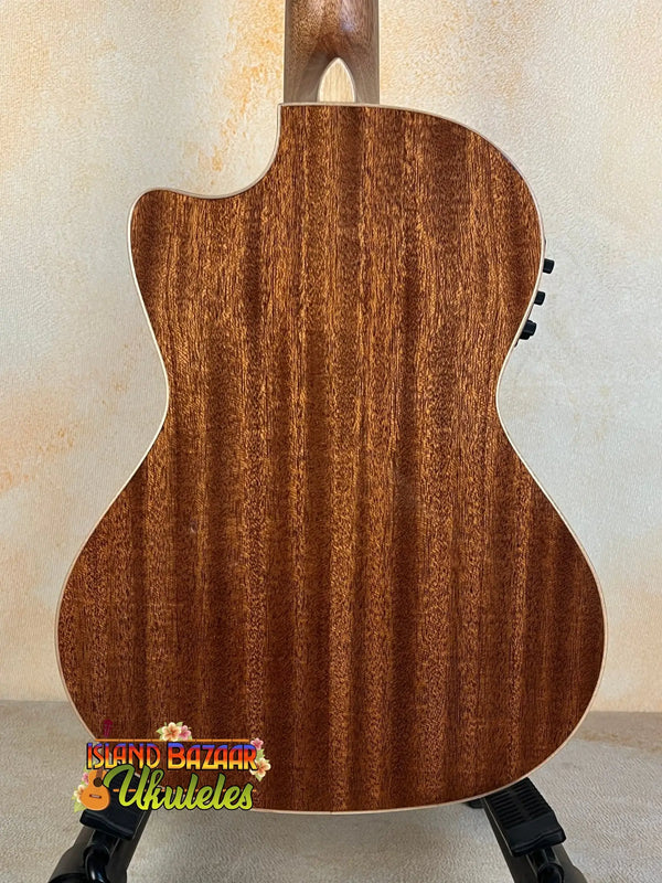 Acoustic guitar with brown wooden back panel beside Kala KA-SMH-TG-CE Tenor Electric Ukulele