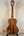 Classical acoustic guitar with a rich brown body alongside Kala KA-SMH-TG ukulele