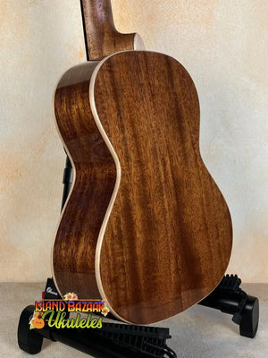 Acoustic guitar with rich brown body, complementing Kala KA-SMH-TG Solid Mahogany Tenor Ukulele