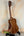 Wooden Kala KA-SMH-TG Solid Mahogany Tenor Ukulele on a sleek black stand