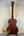 Wooden acoustic guitar with dark mahogany finish next to Kala KA-SMHT Tenor Ukulele
