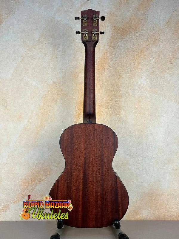 Wooden acoustic guitar with dark mahogany finish next to Kala KA-SMHT Tenor Ukulele