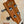 Wooden headstock of Kala KA-STGE-C Tenor Ukulele with tuning pegs and strings