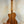 Wooden Kala KA-STGE-C Tenor Ukulele with a natural finish on a display stand