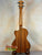 Wooden Kala KA-STGE-C Tenor Ukulele with a natural finish on a display stand