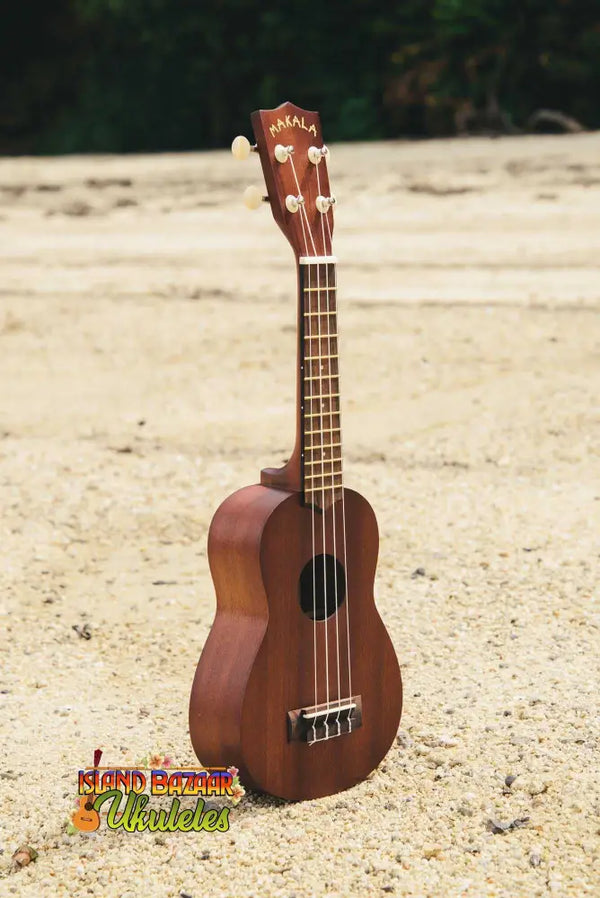 Brown wooden Kala Makala-Series Satin Mahogany Soprano Ukulele Model MK-S on sand