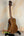 Wooden Kala SA-C Concert Ukulele on black stand, showcasing spruce & acacia design