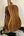 Acoustic guitar with walnut wood back on stand, highlighting Kala SA-C Concert Ukulele design