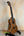 Wooden Kala SA-C Concert Ukulele on a black stand, showcasing Spruce & Acacia design