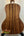 Acoustic guitar with wooden back panel on a stand, featuring Kala SA-C Concert Ukulele design