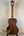 Classical acoustic guitar with dark wood finish near Kala SA-T Tenor Ukulele display