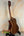 Wooden acoustic guitar with dark brown finish on black stand for Kala SA-TE-C Tenor Electric