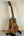 Wooden Kala SMH-CG Concert Ukulele on a black stand showcasing solid mahogany elegance