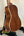 Wooden acoustic guitar on black stand for Kala SMH-CG Concert Ukulele with solid mahogany