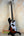 Sunburst-colored Precision Bass guitar on a stand with Kala Solid Body design