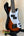 Sunburst-colored Precision Bass guitar with white pickguard in Kala Solid Body 4-String Tobacco Burst Fretted U•BASS® Ukulele