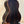 Dark wooden acoustic guitar on a stand next to Kala Solid Spruce Tenor Ukulele Striped