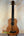 Wooden Kala U-Bass Nomad Acoustic-Electric Bass Ukulele with dark fretboard and four strings