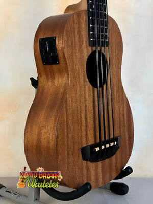 Wooden Kala U-Bass Nomad Acoustic-Electric Bass Ukulele with black hardware on stand