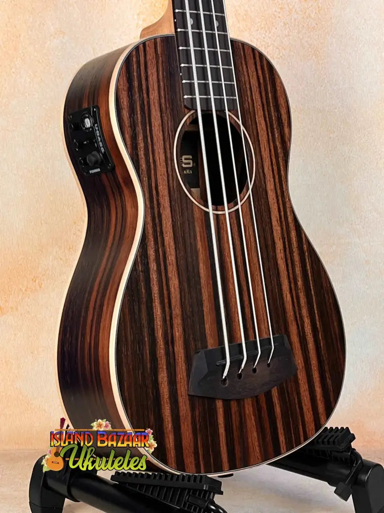 Striped Ebony Acoustic-Electric Bass Ukulele with four strings and a black bridge