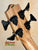 Bass guitar headstock with black tuning pegs on Kala Wanderer U-Bass Ukulele