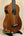 Wooden Kala Wanderer U-BASS Ukulele Acoustic-Electric with four strings on a stand