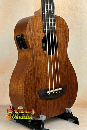 Wooden Kala Wanderer U-BASS Ukulele Acoustic-Electric with four strings on a stand