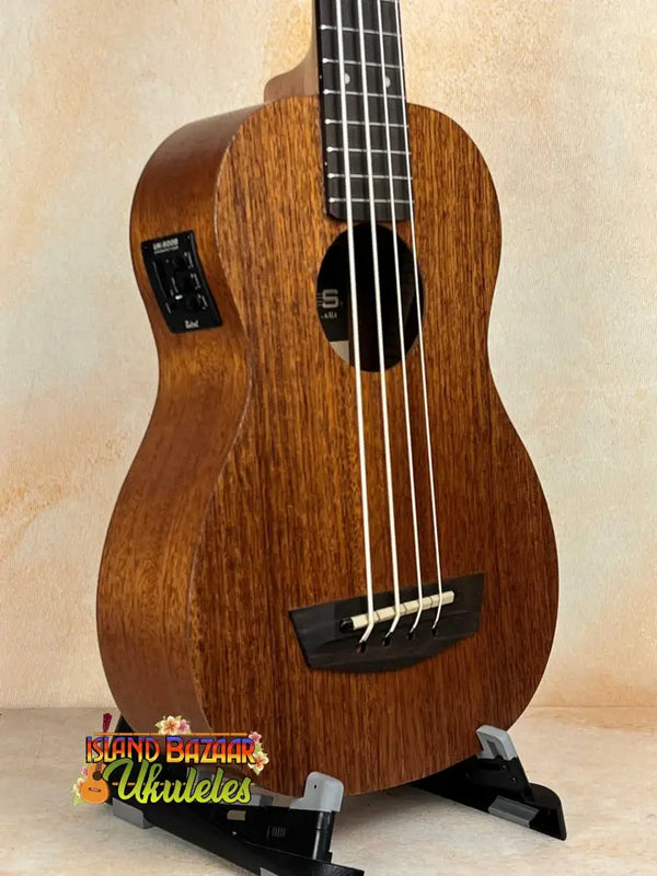 Wooden Kala Wanderer U-BASS Ukulele Acoustic-Electric with four strings on a stand