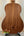 Wooden acoustic guitar on a black stand with Kala Wanderer U-Bass Ukulele nearby