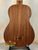 Wooden acoustic guitar on a black stand with Kala Wanderer U-Bass Ukulele nearby