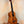 Wooden Kamaka Concert Ukulele HF-2 in solid Hawaiian Koa on a stand with dark fretboard