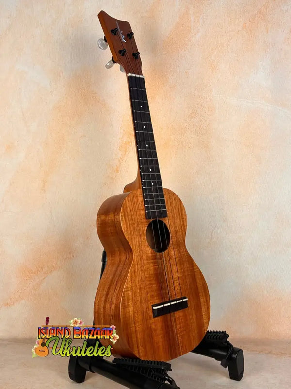 Wooden Kamaka Concert Ukulele HF-2 in solid Hawaiian Koa on a stand with dark fretboard