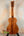 Wooden Kamaka Concert Ukulele HF-2 in solid Hawaiian Koa finish on black stand