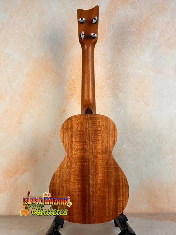 Wooden Kamaka Concert Ukulele HF-2 in solid Hawaiian Koa finish on black stand