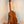 Wooden Kamaka Concert Ukulele HF-2 in solid Hawaiian Koa on a black stand