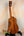 Wooden Kamaka Concert Ukulele HF-2 in solid Hawaiian Koa on a black stand