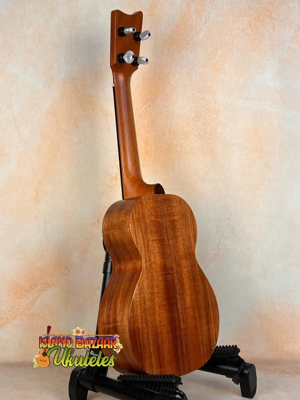 Wooden Kamaka Concert Ukulele HF-2 in solid Hawaiian Koa on a black stand