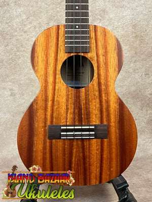 Brown wooden tenor ukulele showcasing the Kamaka HF-3 design and Hawaiian koa tone