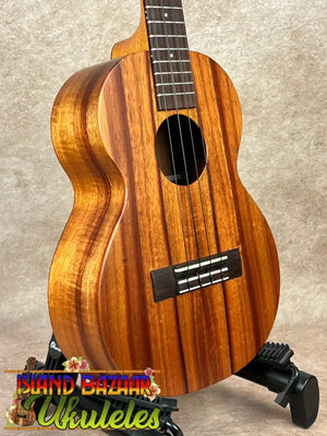 Brown wooden Kamaka HF-3 tenor ukulele showcasing classic solid koa design