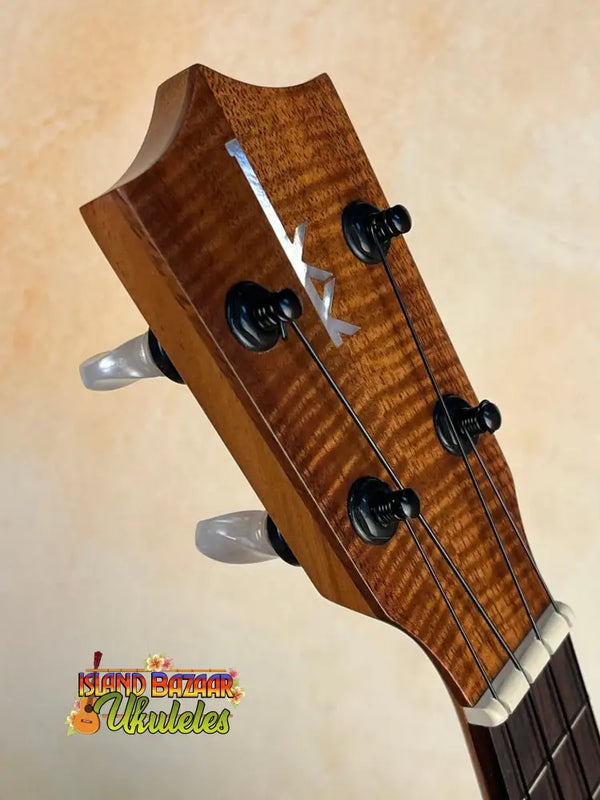 Wooden headstock of Kamaka HP-1 Pineapple Soprano Ukulele with tiger stripe pattern