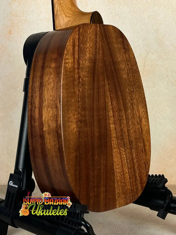 Wooden back panel of Kamaka HP-1 Pineapple Soprano Ukulele with rich brown grain